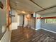 Bright living room with wood-look flooring, neutral paint, and storage cabinets at 333 Mount View Ln # 266 B, New London, NC 28127