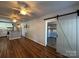 Open living room area with a modern barn door leading to another room, seamlessly connecting living spaces at 333 Mount View Ln # 266 B, New London, NC 28127