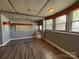 Spacious living room with wood-look flooring and large windows for ample natural light at 333 Mount View Ln # 266 B, New London, NC 28127
