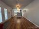 Open living room with hardwood floors flowing into a bright kitchen with white cabinets and a kitchen island at 333 Mount View Ln # 266 B, New London, NC 28127