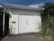 View of a detached outbuilding with white siding and double doors, alongside some vegetation at 333 Mount View Ln # 266 B, New London, NC 28127