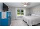 Bright bedroom with a bed, large window with backyard view, wood-look flooring, and a decorative dresser at 360 Sexton St, Kannapolis, NC 28081
