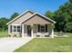 Charming single-story home with neutral siding, black door, and a well-manicured lawn and front patio seating area at 360 Sexton St, Kannapolis, NC 28081