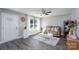 Inviting living room showcasing stylish decor, a cozy sofa, wood-look floors, and a sunlit window with sheer curtains at 360 Sexton St, Kannapolis, NC 28081