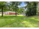 Spacious backyard with lush lawn, mature trees, patio, and additional storage shed at 3969 Sheffield Dr, Charlotte, NC 28205