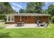 Large brick home with a patio, grill, and ample seating in the spacious backyard at 3969 Sheffield Dr, Charlotte, NC 28205