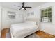 Bright bedroom featuring hardwood floors, ceiling fan, and two windows providing natural light at 3969 Sheffield Dr, Charlotte, NC 28205
