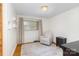 Inviting bedroom with wooden floors, cozy chair, natural light, and neutral decor at 3969 Sheffield Dr, Charlotte, NC 28205