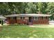 Charming brick home with manicured lawn and mature trees, offering great curb appeal at 3969 Sheffield Dr, Charlotte, NC 28205