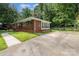 Charming brick home with a well-maintained lawn, mature landscaping, and paved driveway at 3969 Sheffield Dr, Charlotte, NC 28205