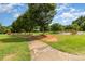 Scenic view of park, showcasing walking path, playground, and abundant green space with mature trees at 3969 Sheffield Dr, Charlotte, NC 28205