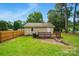Backyard view featuring a wood deck, green grass, and a wood fence at 407 Cummings St, Rock Hill, SC 29730
