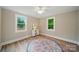 Bright, neutral bedroom with wood-look floors, with plenty of natural light and a ceiling fan at 407 Cummings St, Rock Hill, SC 29730