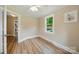 Bright bedroom with wood floors, a window view of greenery, and natural light at 407 Cummings St, Rock Hill, SC 29730