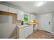 Kitchenette featuring white cabinets, butcher block countertops, a sink, and natural light at 407 Cummings St, Rock Hill, SC 29730