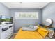 This cozy bedroom has yellow accents and a TV and dresser at 411 Belvedere Cir, Kings Mountain, NC 28086
