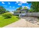 Traditional home featuring a long driveway, green lawn, and partially fenced yard at 411 Belvedere Cir, Kings Mountain, NC 28086