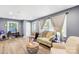 Comfortable living room offering natural light from large windows, wood floors, and stylish furnishings at 411 Belvedere Cir, Kings Mountain, NC 28086