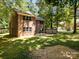 View of the home's backyard featuring a brick facade and a patio perfect for outdoor enjoyment at 4444 Steepleton Way, Charlotte, NC 28215