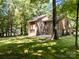 The backyard has mature trees and a brick house, offering a sense of privacy at 4444 Steepleton Way, Charlotte, NC 28215