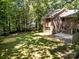 Home backyard with a concrete patio, large green lawn, and mature trees providing shade and privacy at 4444 Steepleton Way, Charlotte, NC 28215