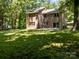 Spacious backyard featuring lush grass and mature trees providing privacy and shade at 4444 Steepleton Way, Charlotte, NC 28215