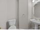 Powder room showcasing a pedestal sink, toilet, and neutral wall color at 4444 Steepleton Way, Charlotte, NC 28215