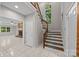 Bright entryway with wooden staircase, tile flooring, and a glimpse of the living room with a fireplace at 4444 Steepleton Way, Charlotte, NC 28215