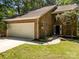 Inviting front entrance of a brick home with a two-car garage at 4444 Steepleton Way, Charlotte, NC 28215