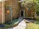 Beautiful front entrance features an interesting metal sun decoration and landscape at 4444 Steepleton Way, Charlotte, NC 28215