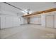 Spacious garage with storage cabinets and shelving, offering ample room for vehicles and organization at 4444 Steepleton Way, Charlotte, NC 28215