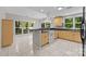 Open kitchen and dining area featuring light wood cabinets, stainless steel appliances, and a backyard view at 4444 Steepleton Way, Charlotte, NC 28215