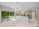 Open kitchen and dining area featuring light wood cabinets, stainless steel appliances, and a backyard view at 4444 Steepleton Way, Charlotte, NC 28215
