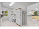 Bright laundry room with washer, dryer, sink, and cabinetry, conveniently located near the kitchen at 4444 Steepleton Way, Charlotte, NC 28215
