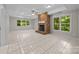 Spacious living room with tiled floors and a brick fireplace at 4444 Steepleton Way, Charlotte, NC 28215