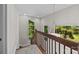 Bright staircase with wooden banister and large windows offering natural light and wooded views at 4444 Steepleton Way, Charlotte, NC 28215