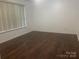 Spacious bedroom with laminate flooring and a neutral color scheme at 4454 Glenlea Commons Dr, Charlotte, NC 28216