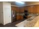 Updated kitchen with stainless steel appliances, granite countertops, and wooden cabinets at 4454 Glenlea Commons Dr, Charlotte, NC 28216