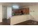 Open kitchen featuring stainless steel appliances and a breakfast bar overlooking the dining area at 4454 Glenlea Commons Dr, Charlotte, NC 28216