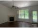 Cozy living room with a fireplace, ceiling fan, and sliding glass door to the backyard at 4454 Glenlea Commons Dr, Charlotte, NC 28216