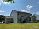 Large, grassy backyard with a patio area and an enclosed sunroom attached to this two-story home at 5009 Brook Valley Run, Monroe, NC 28110