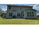 Spacious backyard with a patio, grill, seating, and a sunroom addition, ideal for outdoor gatherings at 5009 Brook Valley Run, Monroe, NC 28110