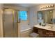 Bright bathroom with a soaking tub, glass shower, vanity, and large mirror at 5009 Brook Valley Run, Monroe, NC 28110