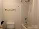 Bright bathroom with a shower-tub combo, neutral walls, and gold hardware at 5009 Brook Valley Run, Monroe, NC 28110