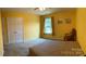 Bright bedroom featuring neutral carpet, a ceiling fan, and a view of the outdoors at 5009 Brook Valley Run, Monroe, NC 28110