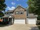 Charming two-story home with brick and vinyl siding, a three-car garage, and a well-maintained front yard at 5009 Brook Valley Run, Monroe, NC 28110