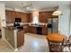 Well-equipped kitchen with wood cabinets, black appliances, and a breakfast nook, perfect for casual dining at 5009 Brook Valley Run, Monroe, NC 28110