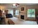 Inviting living area with a fireplace, large windows, and plush carpeting, creating a warm and comfortable atmosphere at 5009 Brook Valley Run, Monroe, NC 28110