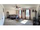 Inviting living room filled with natural light, plush carpet, ceiling fan, and comfortable seating at 5009 Brook Valley Run, Monroe, NC 28110