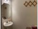 Cozy powder room with a decorative mirror, stylish sconces, and a classic pedestal sink at 5009 Brook Valley Run, Monroe, NC 28110